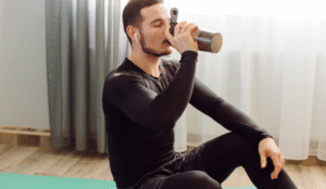 Athlete drinking a protein shake after workout to support protein absorption and muscle recovery using high quality plant based protein powder
