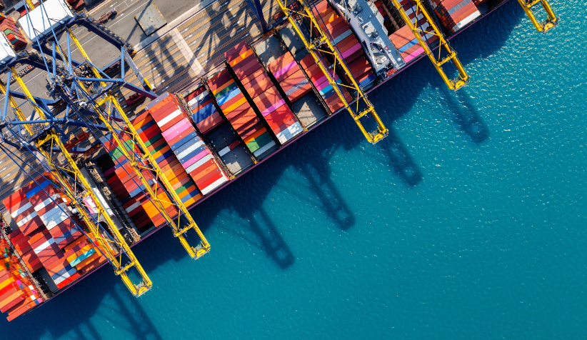 Shipping containers at a global logistics port representing protein supply chain resilience, protein security, global food systems, and diversified protein sourcing including mung bean protein isolate.